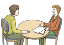 Zwei Personen, die sich an einem Tisch gegenübersitzen und reden